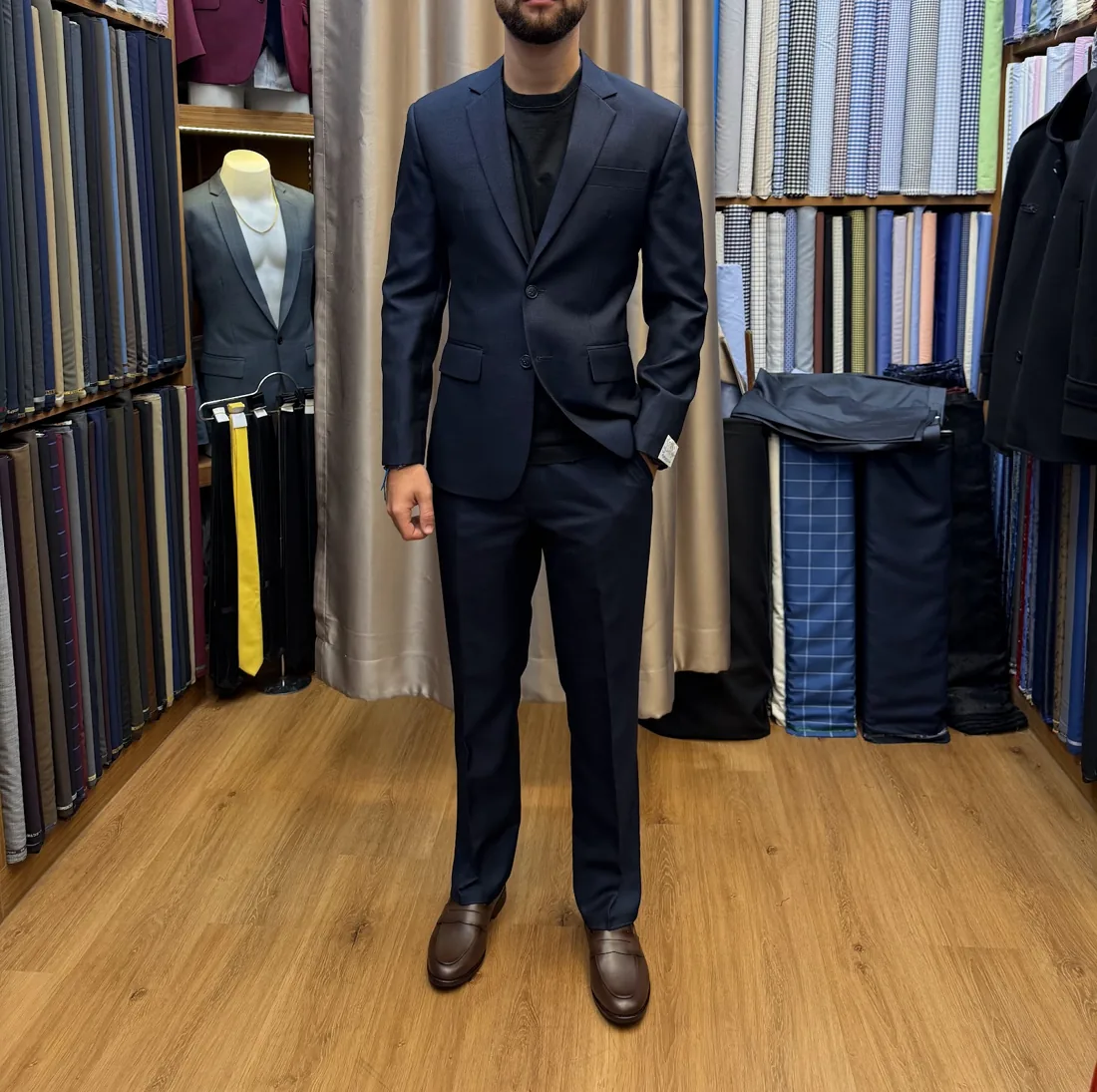 Client in a navy custom suit at the atelier
