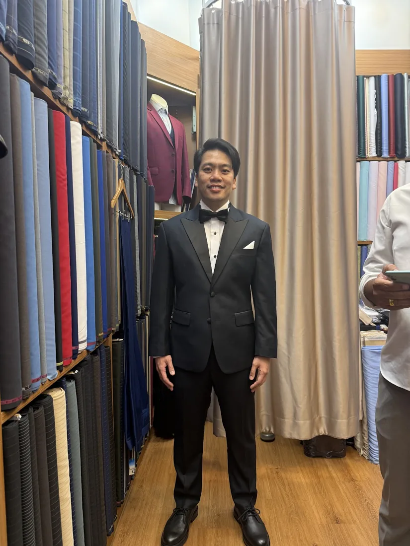 Client in a slim black tuxedo