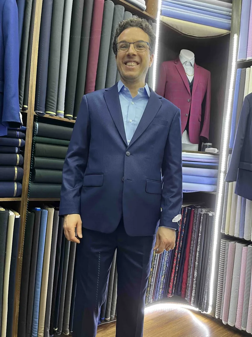 Client in a mid-blue bespoke suit
