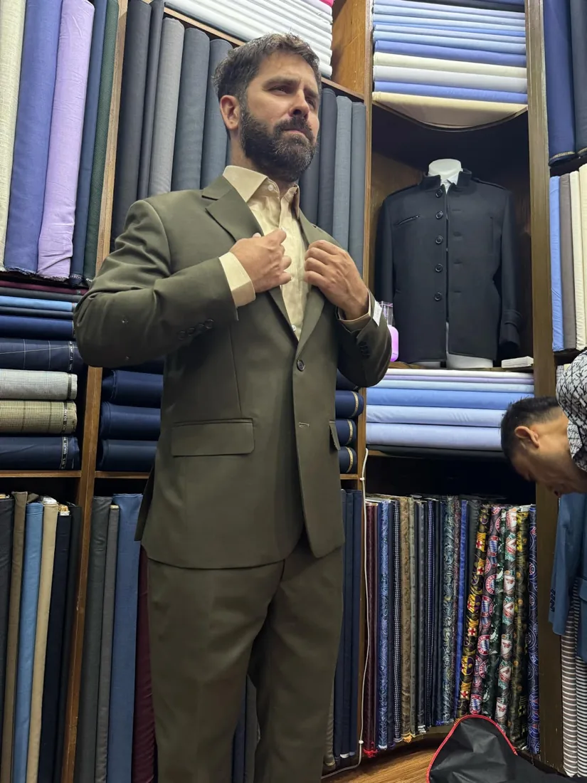 Client in an olive-green custom suit