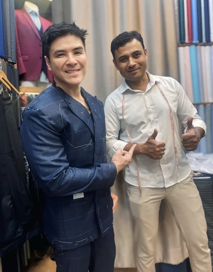 Mr. Santosh with a client in a bespoke navy suit